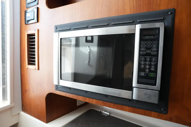 Slide: The Image of Built-in microwave on 2009 Grady-White Express 330 boat interior. - 48