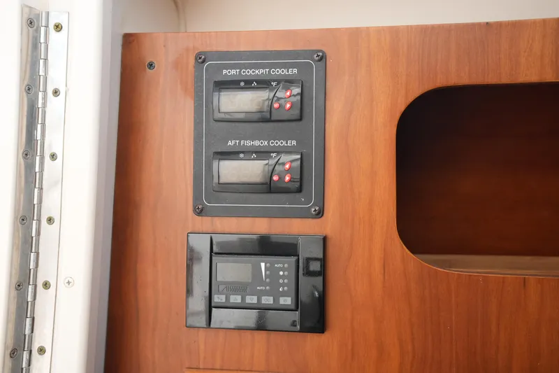 Slide: The Image of Control panel on 2009 Grady-White Express 330 boat, featuring cockpit and fishbox coolers. - 49