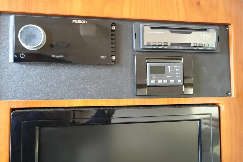 Slide: The Image of Control panel on 2009 Grady-White Express 330 boat with audio and display systems. - 55