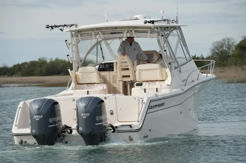 Slide: The Image of 2009 Grady-White Express 330 boat with dual Yamaha 350 engines on water. - 6