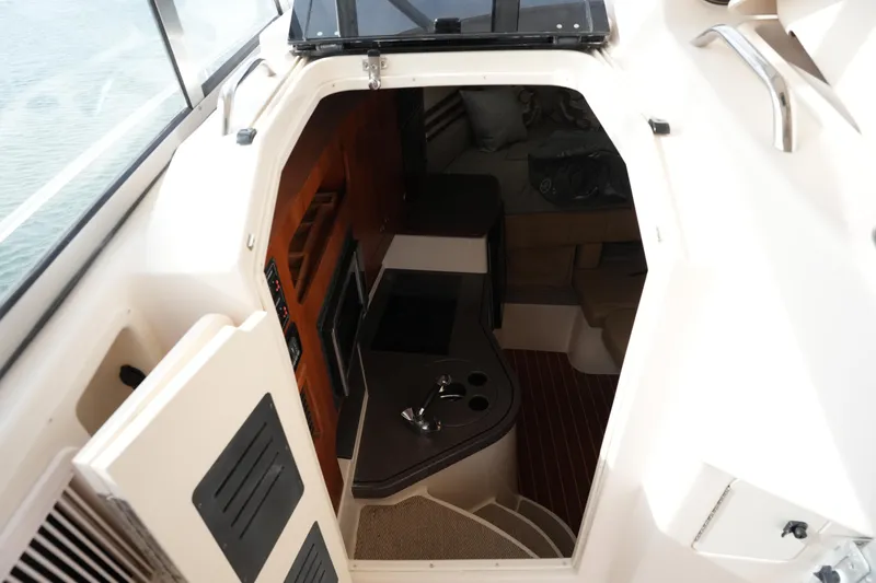 Slide: The Image of Interior cabin view of 2009 Grady-White Express 330 boat, featuring kitchenette and seating area. - 61