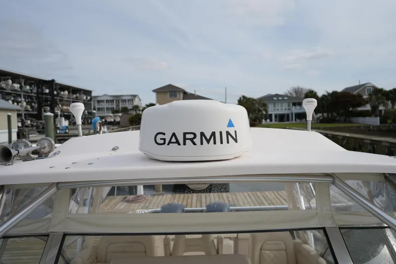 Slide: The Image of 2009 Grady-White Express 330 boat with Garmin radar, docked near waterfront homes. - 65