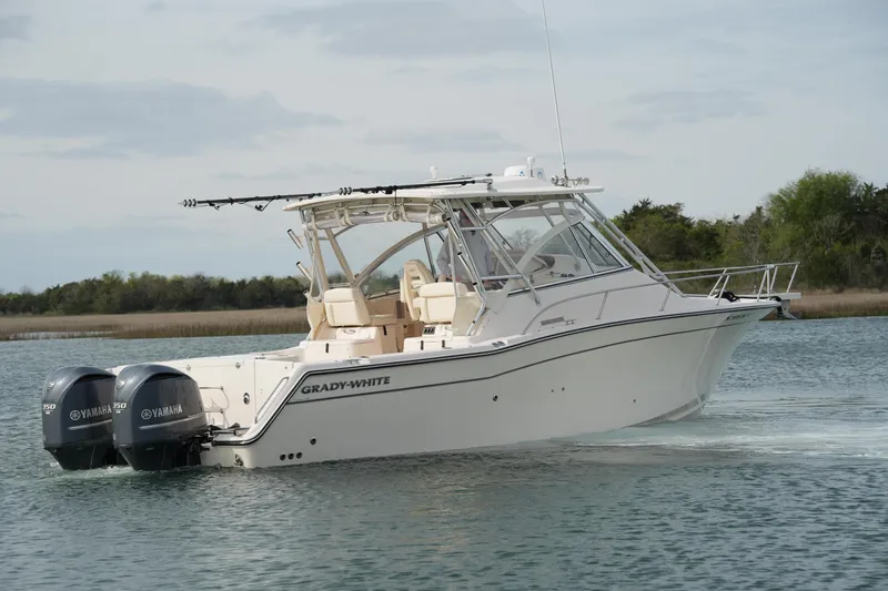Slide: The Image of 2009 Grady-White Express 330 boat with twin Yamaha engines on calm water. - 8