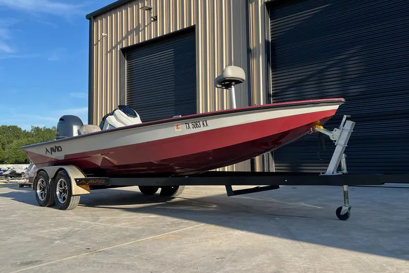 The Image of 2024 Avid 20 XB boat on trailer, parked outside a building. - 0