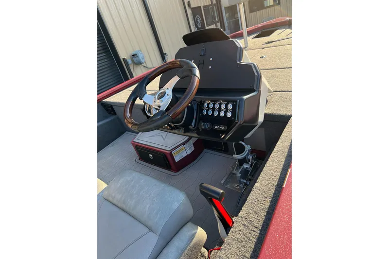 Slide: The Image of 2024 Avid 20 XB boat interior with steering wheel and control panel. - 11