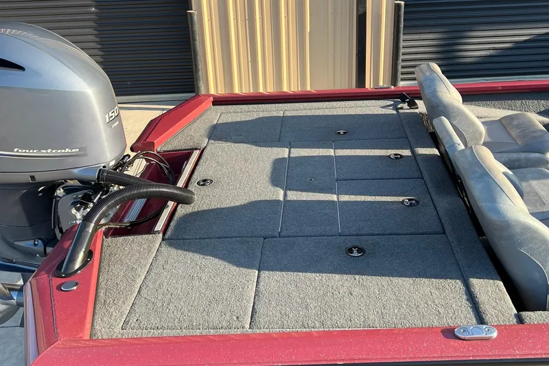 Slide: The Image of 2024 Avid 20 XB boat with four-stroke engine and cushioned seating. - 12