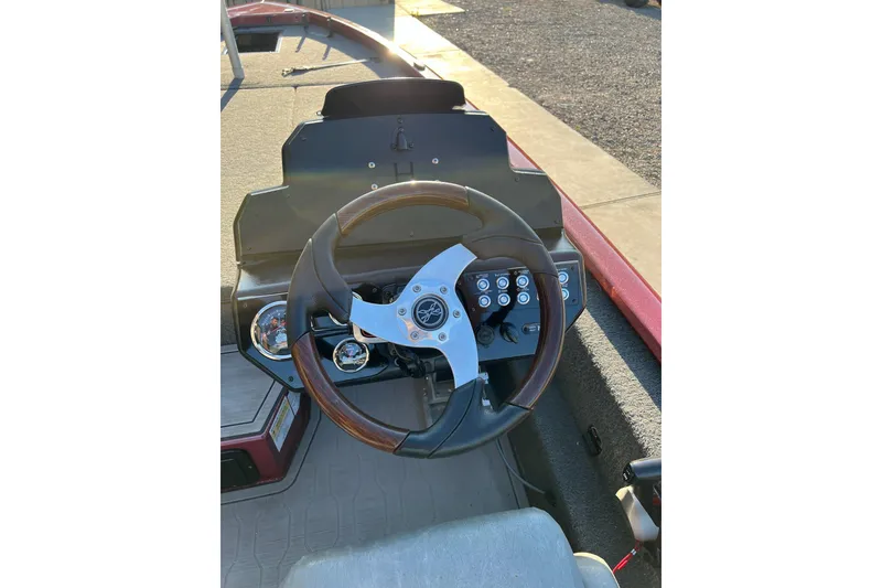 Slide: The Image of Steering wheel and dashboard of 2024 Avid 20 XB boat, featuring modern controls. - 16