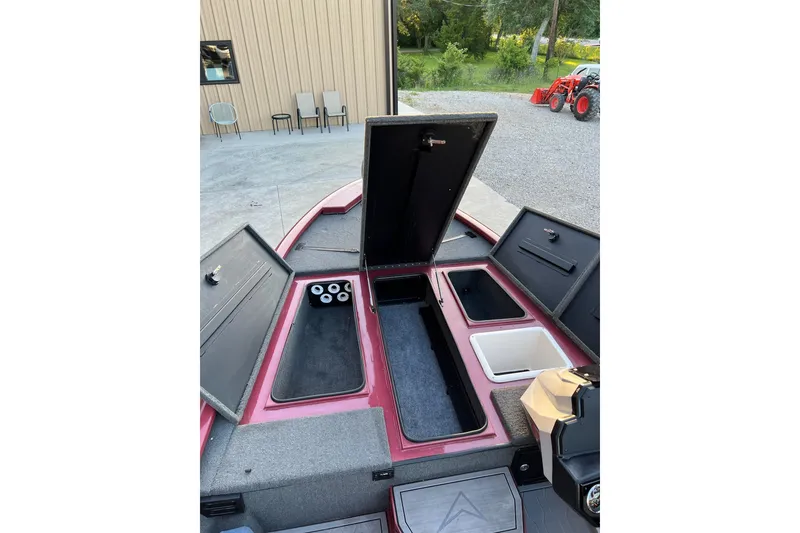 Slide: The Image of 2024 Avid 20 XB boat with open storage compartments and sleek design. - 22