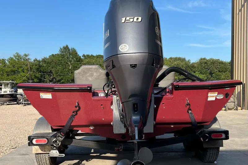 Slide: The Image of 2024 Avid 20 XB boat with Yamaha 150 engine, parked outdoors. - 6