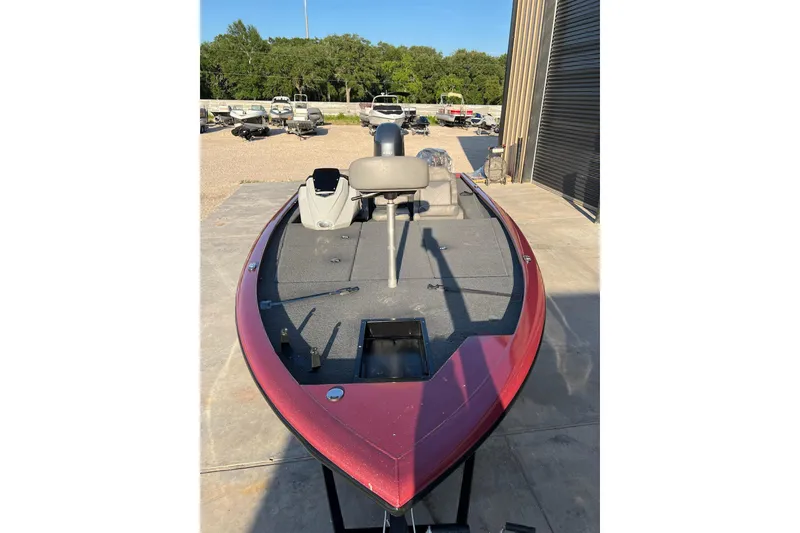 Slide: The Image of 2024 Avid 20 XB boat with red exterior, parked outdoors on concrete. - 7