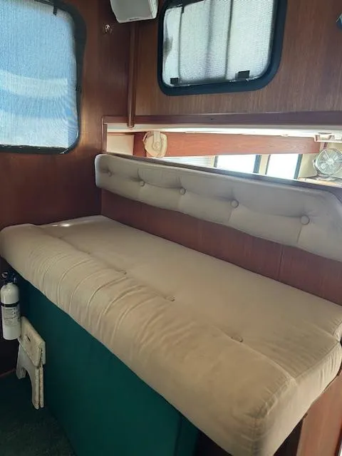 Slide: The Image of Interior of 2001 Nordic Tug 32 with cushioned seating and wooden paneling. - 9