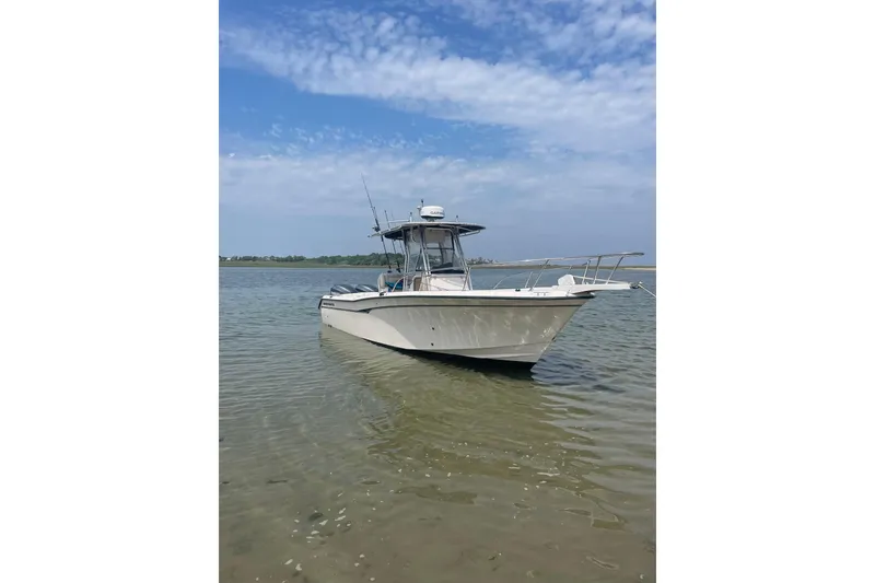 Slide: The Image of 2004 Grady-White Chase 273 boat on calm water under a clear sky. - 1