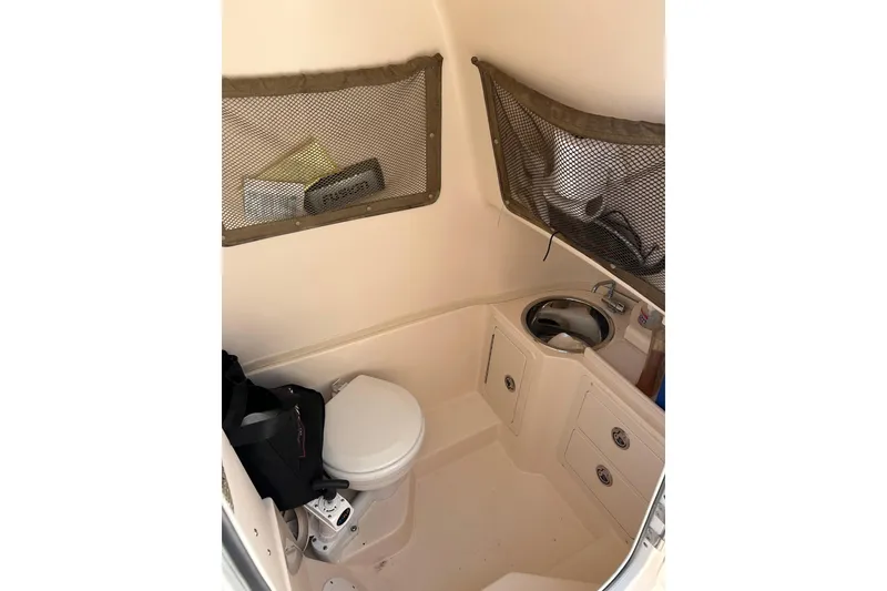 Slide: The Image of 2004 Grady-White Chase 273 boat interior with toilet and sink. - 11