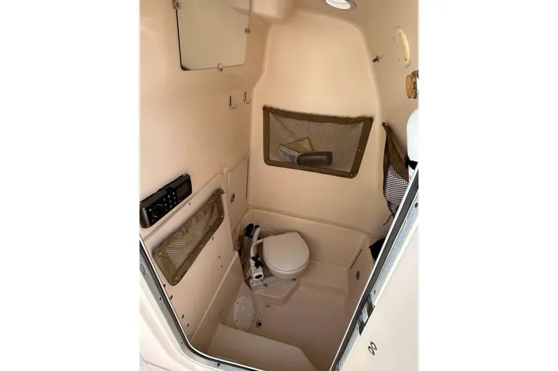 Slide: The Image of 2004 Grady-White Chase 273 boat interior with toilet and storage compartments. - 12