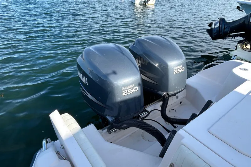 Slide: The Image of Twin Yamaha 250 engines on a 2004 Grady-White Chase 273 boat in water. - 14