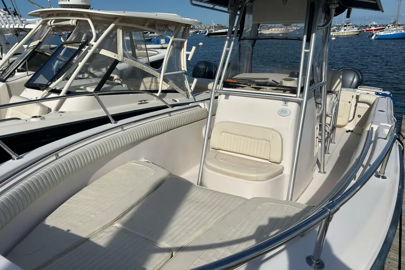 Slide: The Image of 2004 Grady-White Chase 273 boat docked, featuring spacious seating and sleek design. - 3