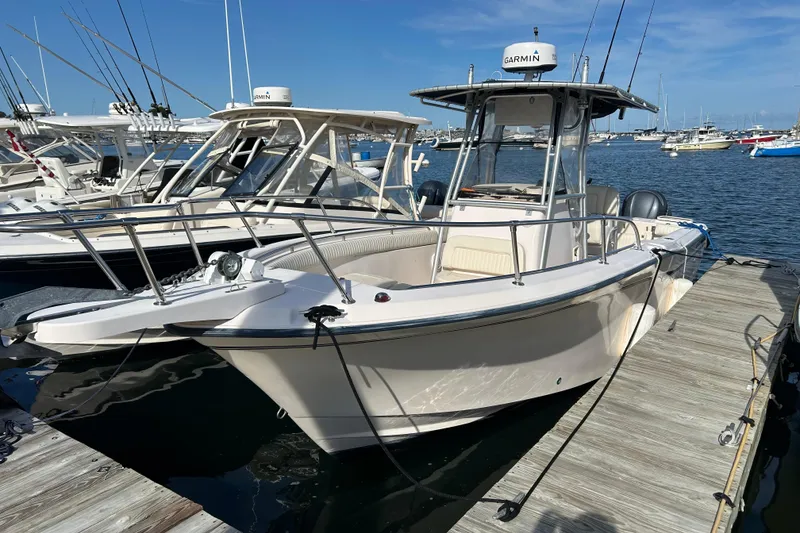 Slide: The Image of 2004 Grady-White Chase 273 boat docked, featuring Garmin equipment, in a marina setting. - 5