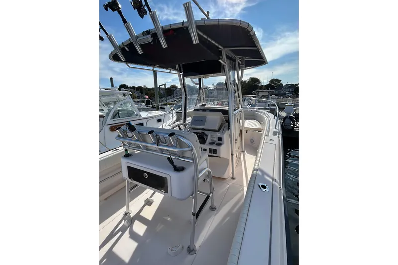 Slide: The Image of 2004 Grady-White Chase 273 boat interior with console and seating, docked at marina. - 8