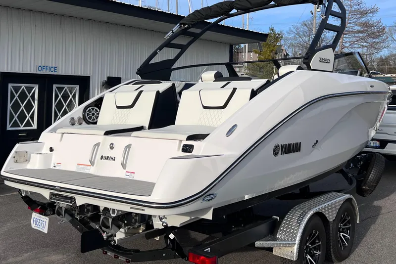 Slide: The Image of 2024 Yamaha Boats 222SD on trailer, parked outside a building. - 10