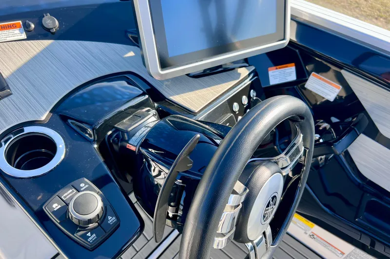 Slide: The Image of 2024 Yamaha Boats 222SD dashboard with steering wheel and touchscreen display. - 15