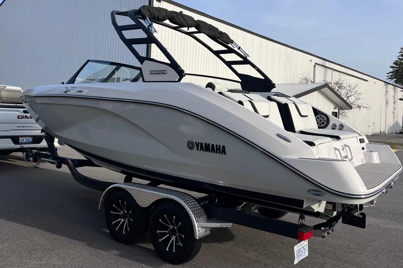 Slide: The Image of 2024 Yamaha Boats 222SD on trailer, sleek design, parked outdoors. - 9