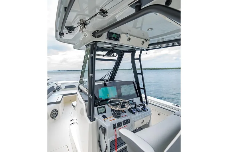 Slide: The Image of 2026 Cobia 305 Center Console boat interior with advanced navigation system. - 11