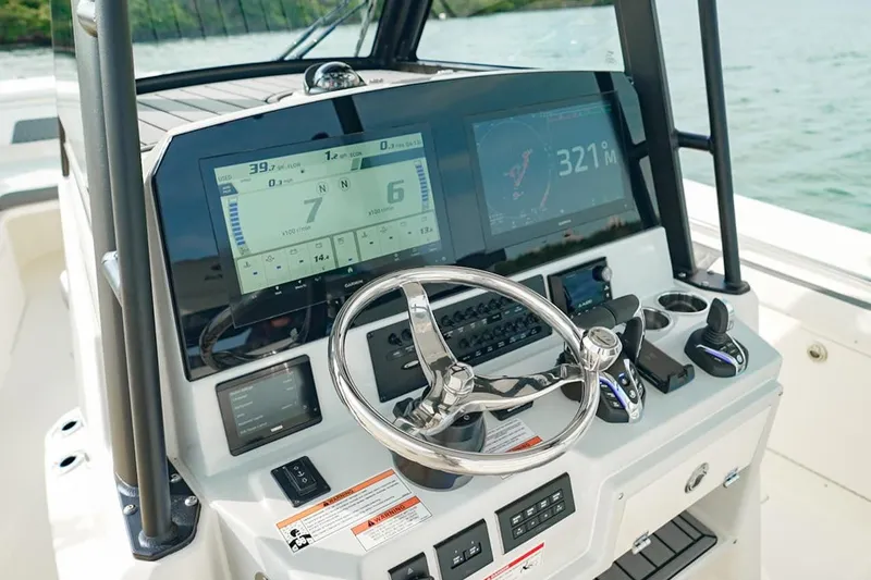 Slide: The Image of 2026 Cobia 305 Center Console boat dashboard with advanced navigation displays. - 14