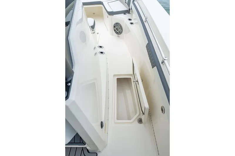 Slide: The Image of 2026 Cobia 305 Center Console boat interior with storage compartment and speaker. - 20