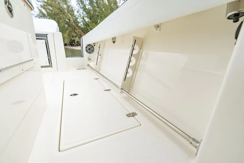 Slide: The Image of 2026 Cobia 305 Center Console boat interior with storage compartments and sleek design. - 23