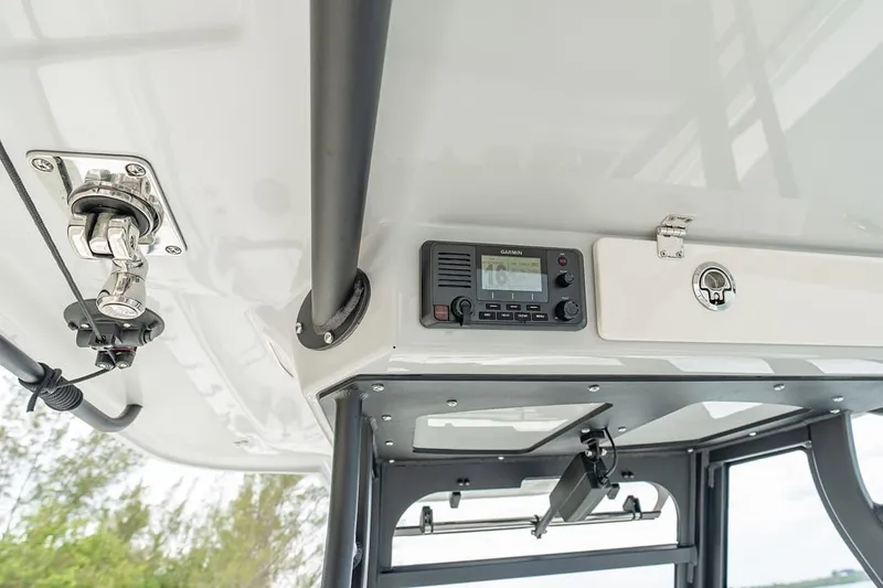 Slide: The Image of 2026 Cobia 305 Center Console boat interior with Garmin electronics and secure storage. - 24