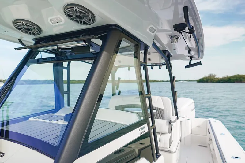 Slide: The Image of 2026 Cobia 305 Center Console boat on calm water, showcasing sleek design and modern features. - 26