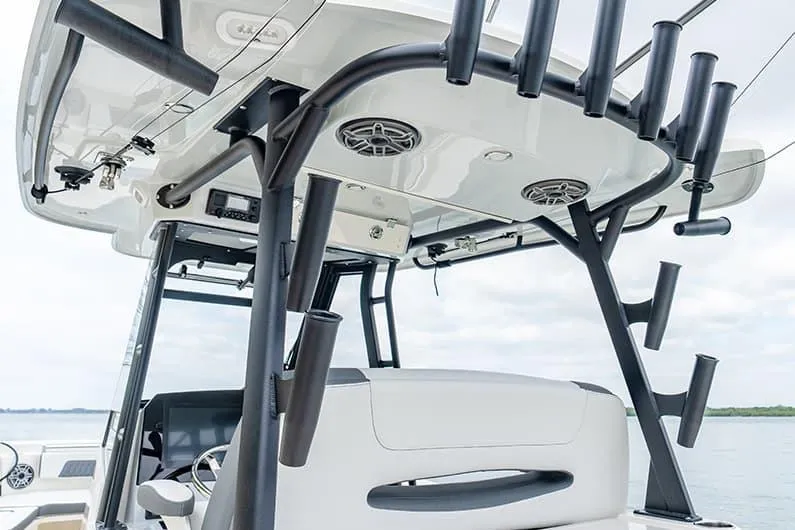 Slide: The Image of 2026 Cobia 305 Center Console boat with rod holders and speakers on the T-top. - 27