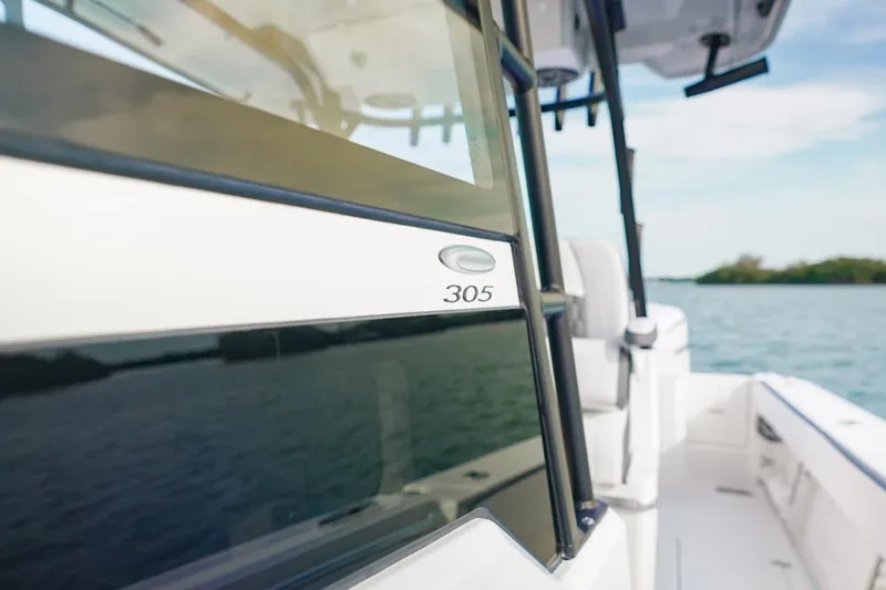 Slide: The Image of 2026 Cobia 305 Center Console boat on water, showcasing sleek design and modern features. - 28