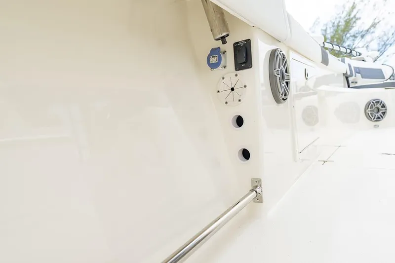 Slide: The Image of 2026 Cobia 305 Center Console boat interior with speakers and rod holders. - 30