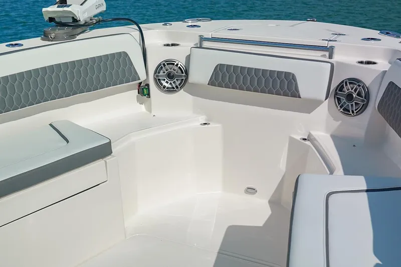 Slide: The Image of 2026 Cobia 305 Center Console boat interior with cushioned seating and speakers. - 31