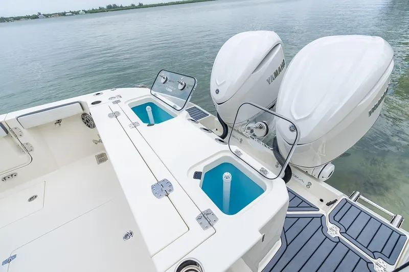 Slide: The Image of 2026 Cobia 305 Center Console boat with dual Yamaha engines on calm water. - 4