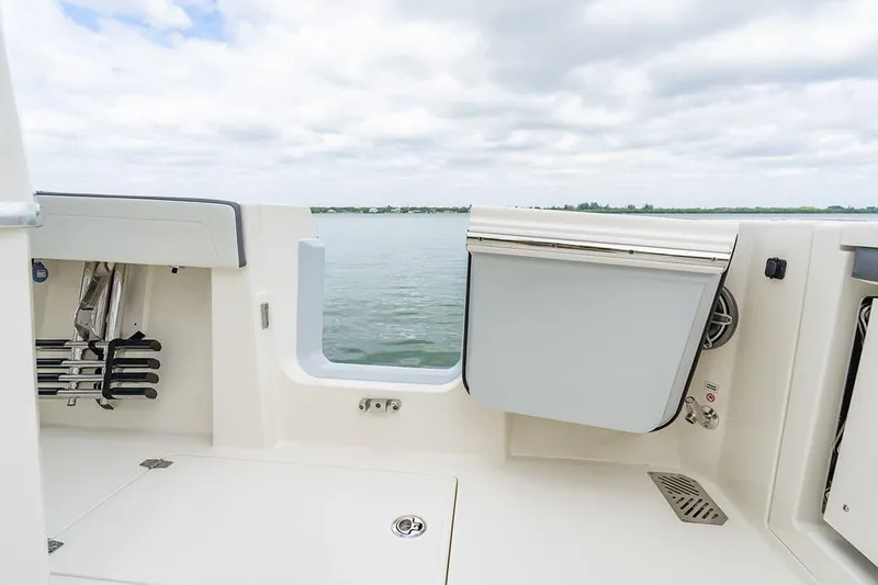 Slide: The Image of 2026 Cobia 305 Center Console boat interior with open water view. - 8