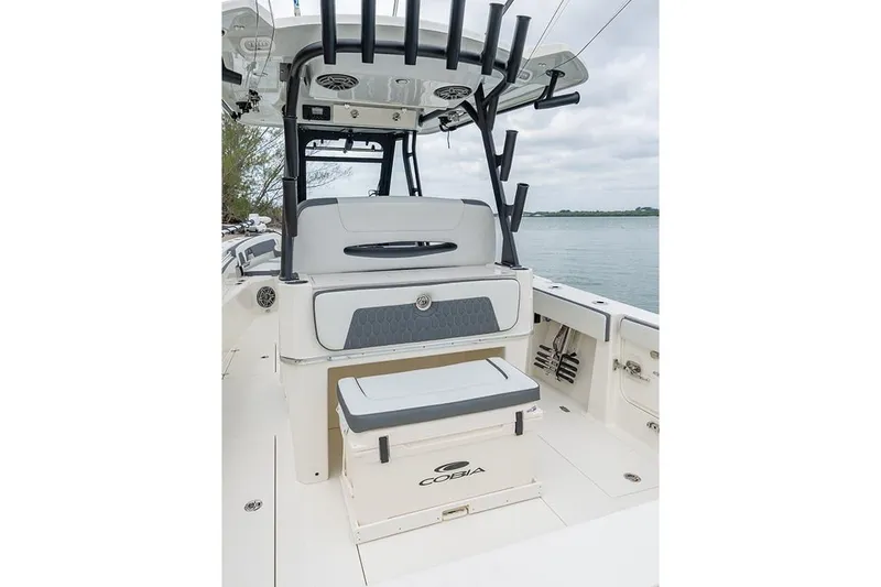 Slide: The Image of 2026 Cobia 305 Center Console boat interior with seating and rod holders. - 9