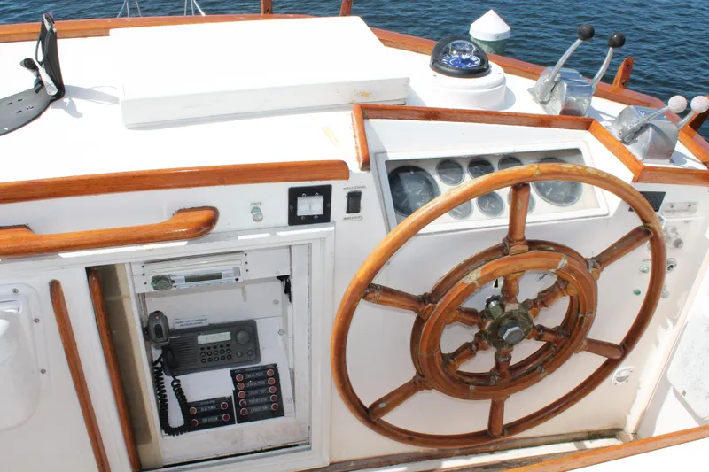 Slide: The Image of 1987 Grand Banks 42 Motoryacht helm with wooden wheel and navigation instruments. - 11