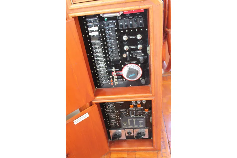 Slide: The Image of Electrical panel of 1987 Grand Banks 42 Motoryacht, showcasing switches and controls. - 16