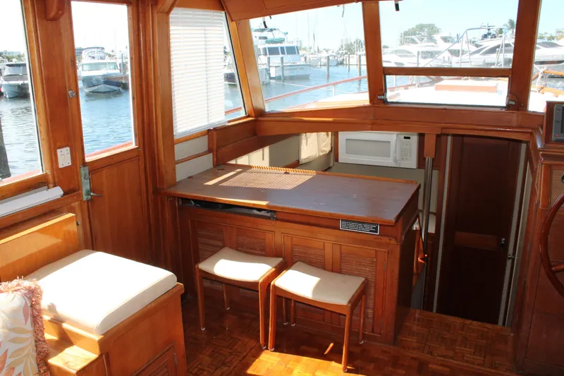 Slide: The Image of Interior of 1987 Grand Banks 42 Motoryacht with wooden cabinetry and marina view. - 17