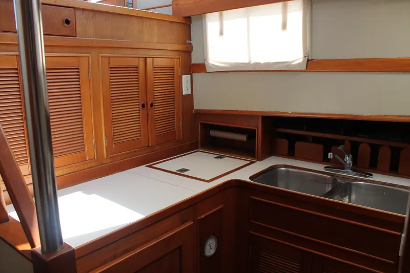 Slide: The Image of 1987 Grand Banks 42 Motoryacht kitchen with wooden cabinets and stainless steel sink. - 20
