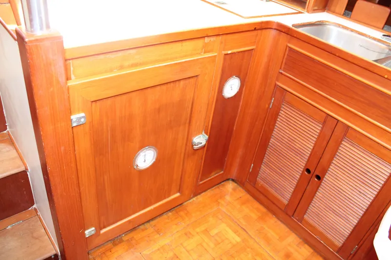 Slide: The Image of Wooden cabinetry in the galley of a 1987 Grand Banks 42 Motoryacht. - 21