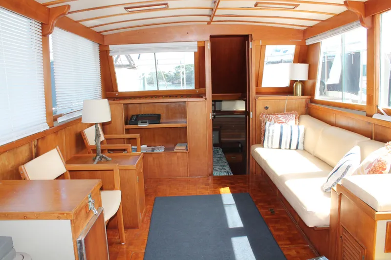 Slide: The Image of Interior of 1987 Grand Banks 42 Motoryacht with wooden furnishings and cozy seating area. - 26