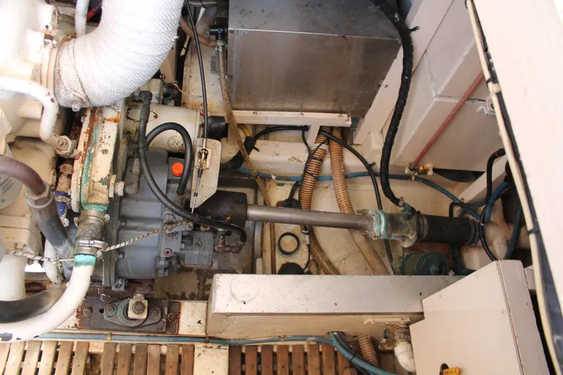 Slide: The Image of Engine room of 1987 Grand Banks 42 Motoryacht, showing mechanical components and piping. - 38