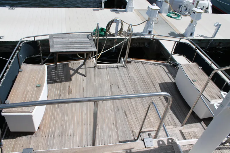 Slide: The Image of Aft deck of 1987 Grand Banks 42 Motoryacht with wooden flooring and seating. - 5