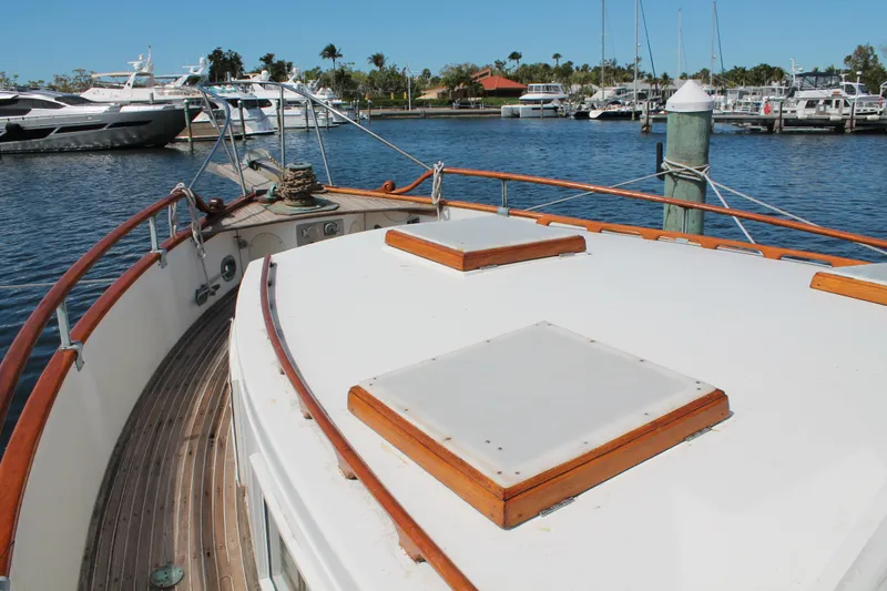 Slide: The Image of 1987 Grand Banks 42 Motoryacht docked at marina, showcasing deck and railing. - 6