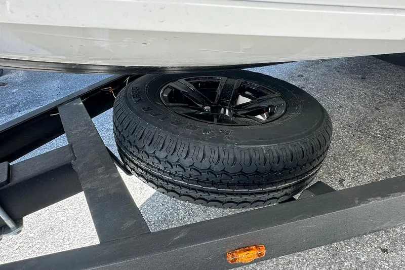 Slide: The Image of 2026 Vexus AVX1880 trailer with spare tire mounted underneath. - 34
