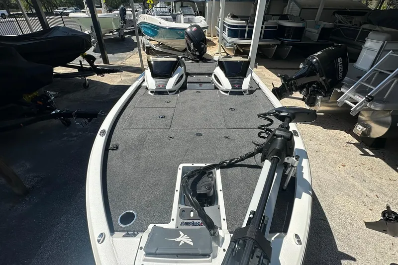 Slide: The Image of 2026 Vexus AVX1880 boat with trolling motor, parked among other boats. - 5