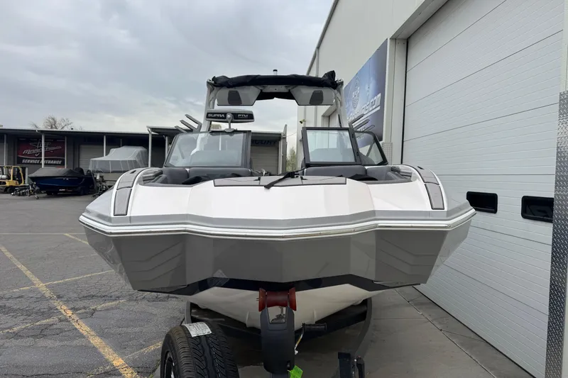 Slide: The Image of 2024 Supra SA 450 boat parked outside a service entrance, showcasing sleek design. - 2